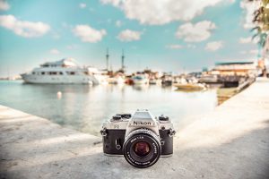 Nikon camera on a wall next to a marina in Greece