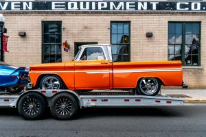 Orange pickup truck on a trailer
