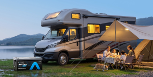 Family eating dinner next to a parked RV